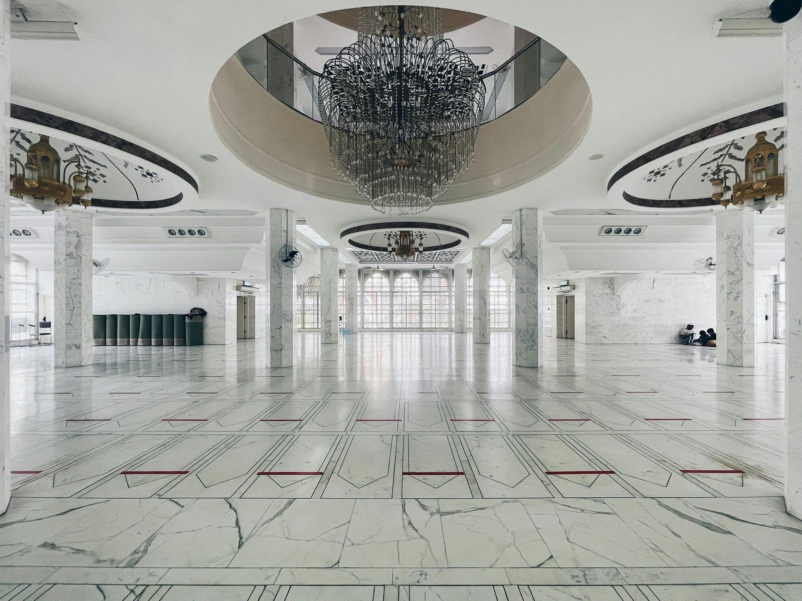 Large marble hall with polished stone floor and columns